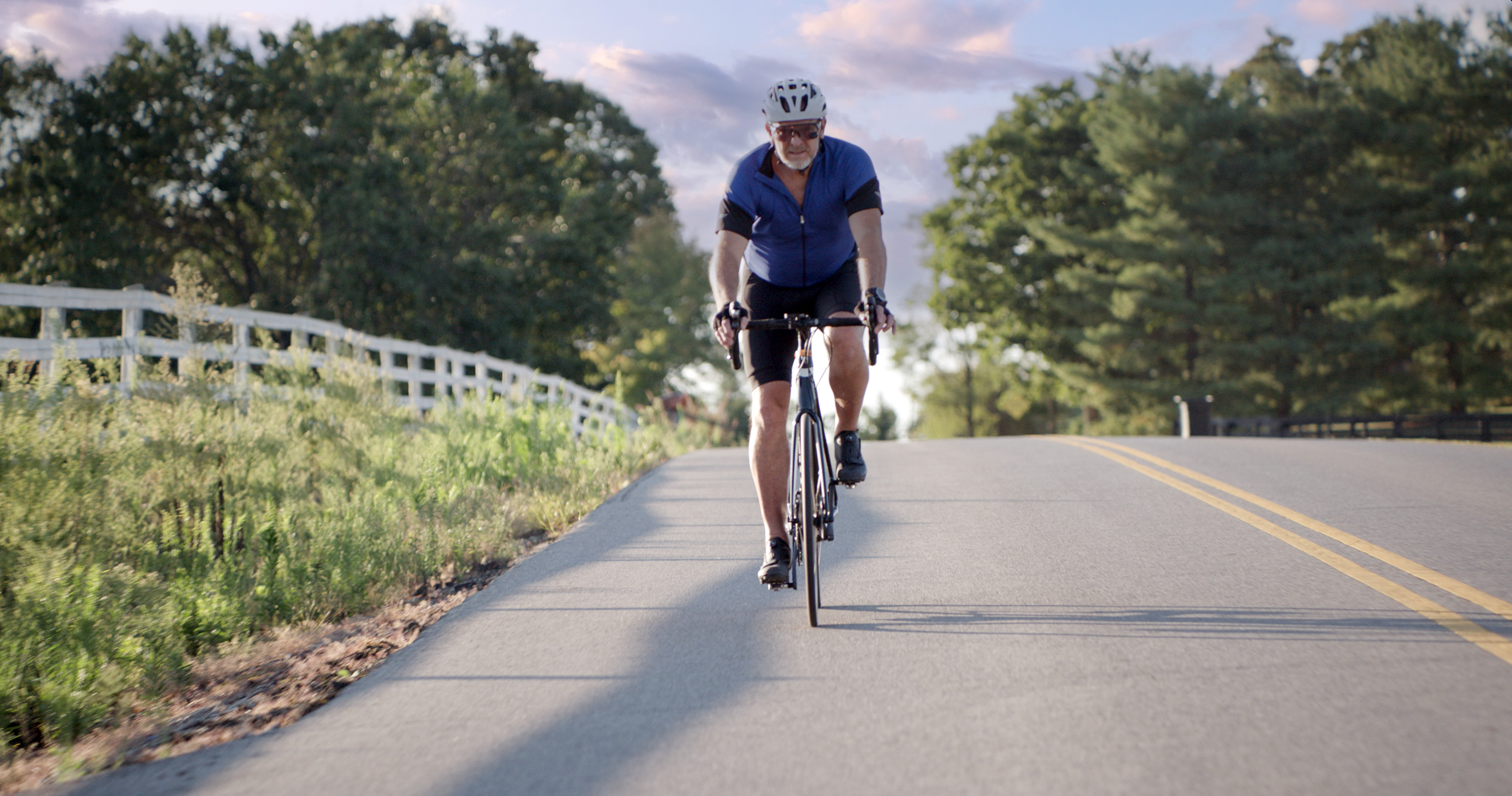 Kevin Smith riding his bike on the road.