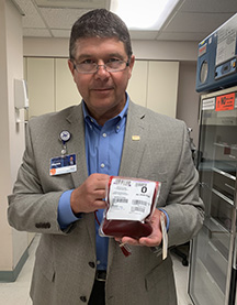 man holding bag of blood