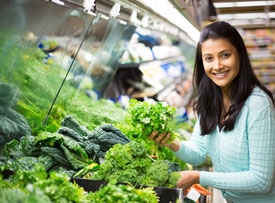 woman picking out veggies at market